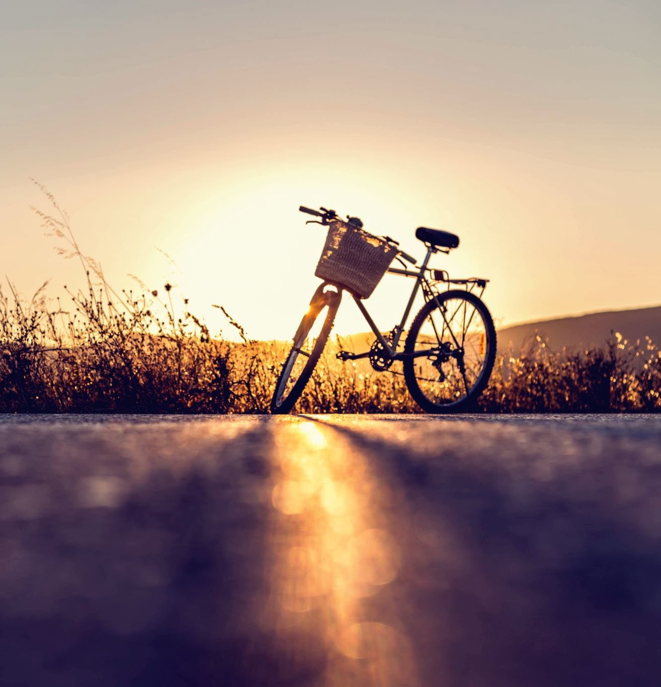 photo of a bike and sunset